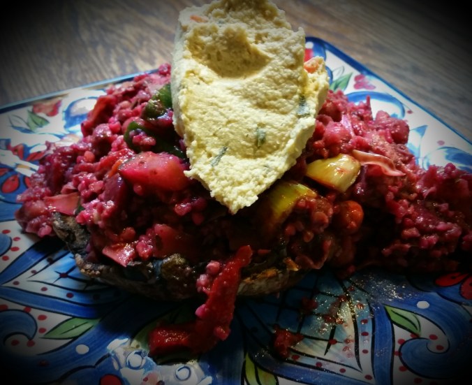 Roasted Portabello Mushroom Stuffed with Veggie-ful Grain Salad Topped with Hummus