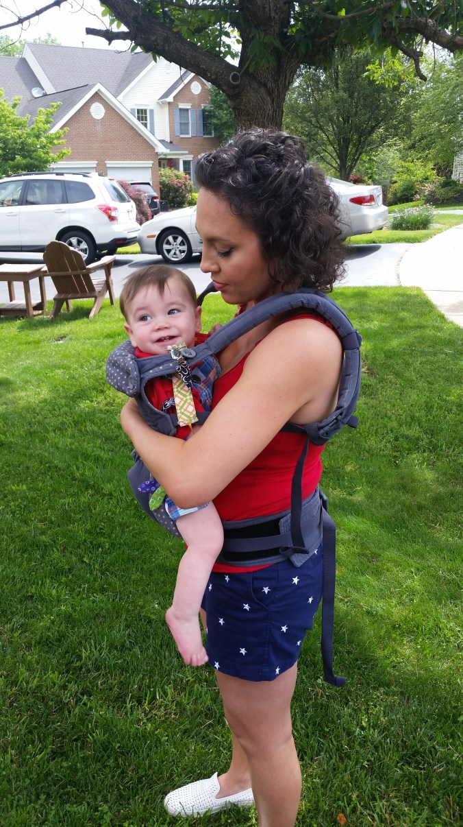 Hold baby up in the carrier so that you could easily crane your neck down to kiss the top of his/her head. Tighten the shoulder straps individually to maintain this positioning.